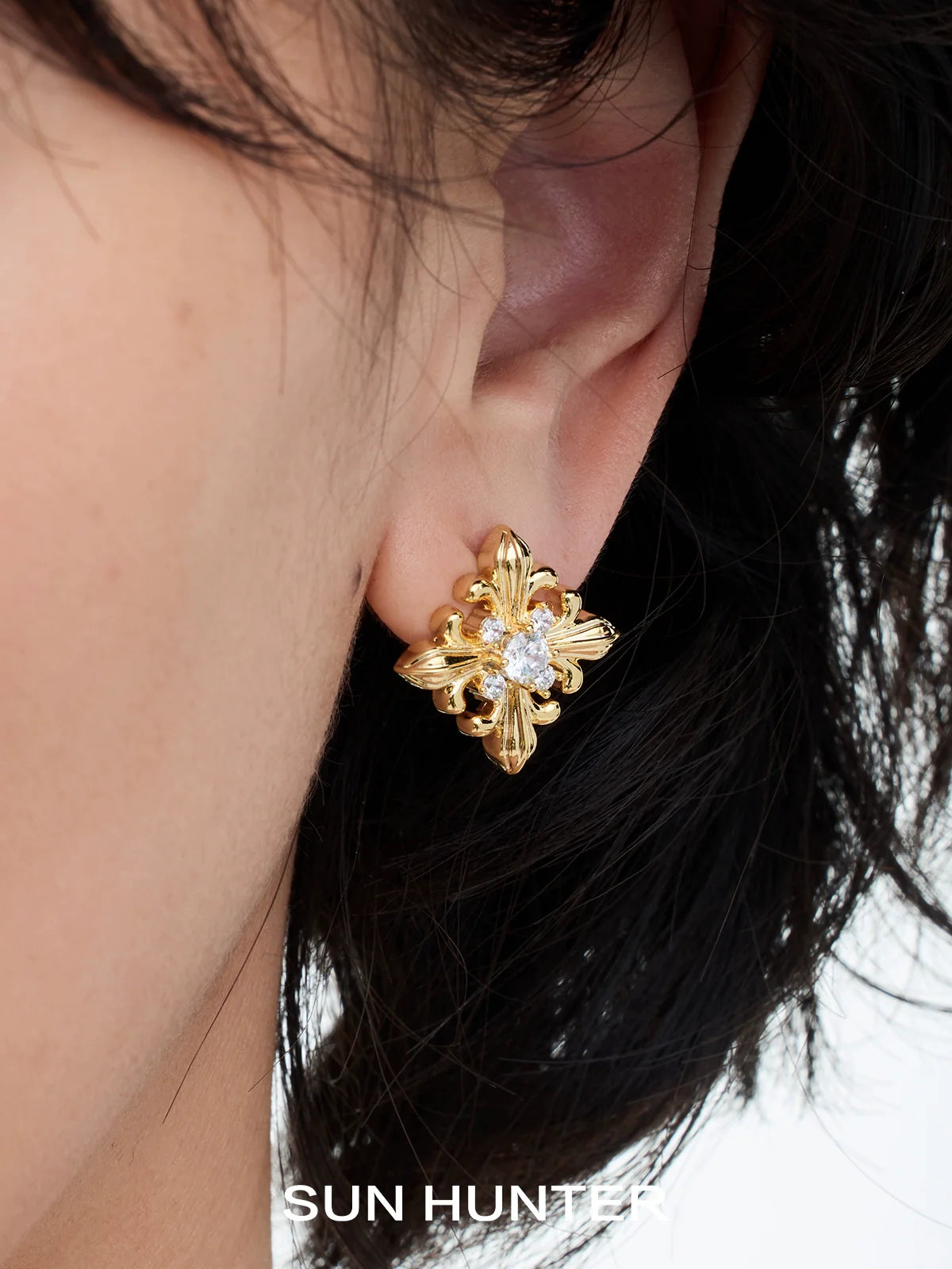 Unique square stud earrings by SUN HUNTER featuring intricate gold design and sparkling center stone