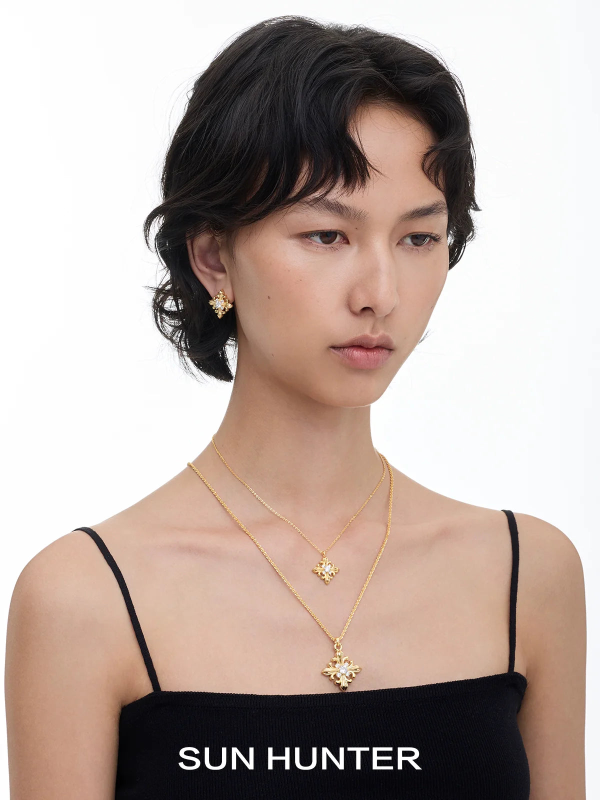Model wearing unique square stud earrings by SUN HUNTER paired with a matching necklace