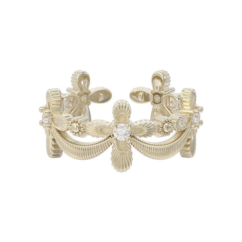 Elegant SUN HUNTER shimmer cross ring featuring intricate floral designs and sparkling accents