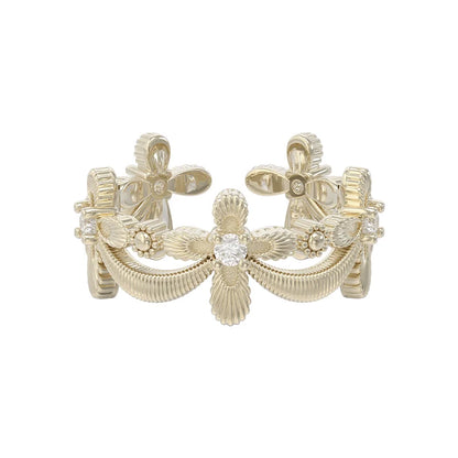 Elegant SUN HUNTER shimmer cross ring featuring intricate floral designs and sparkling accents