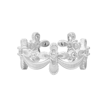 Elegant SUN HUNTER shimmer cross ring in silver with floral design and intricate detailing