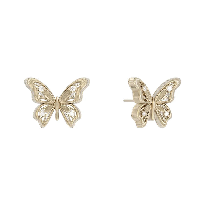 Elegant vintage butterfly earrings in gold tone with intricate detailing and a classic design