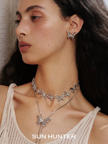 Sun Hunter vintage butterfly earrings in silver showcased on model with matching butterfly necklace