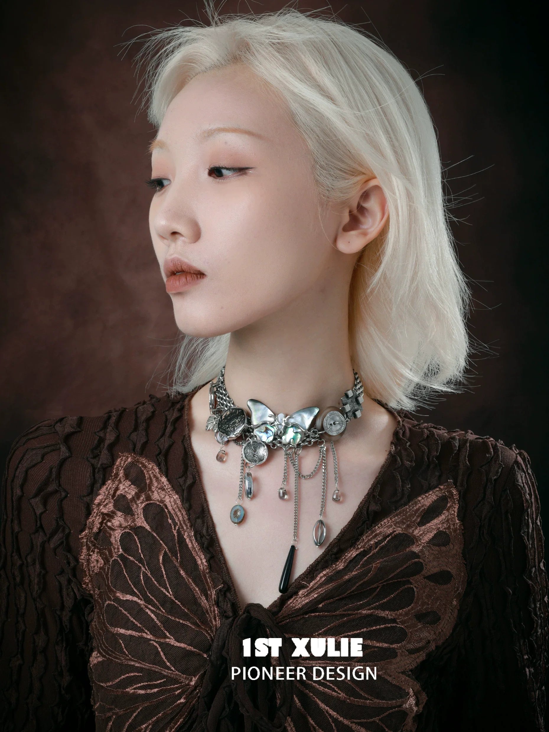Elegant model showcasing a vintage butterfly necklace with silver accents and detailed design