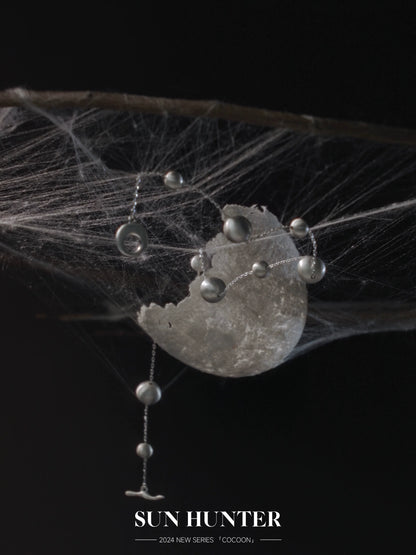 Unique vintage cocoon earrings with delicate design featuring silver accents and a modern aesthetic