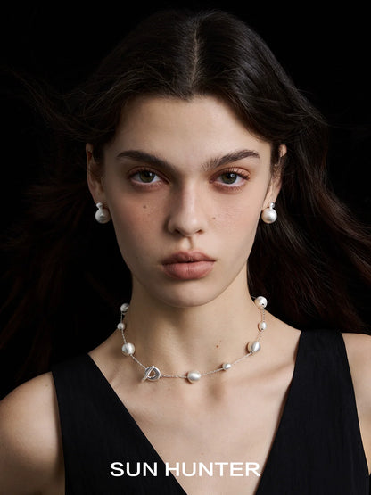 Model wearing vintage cocoon earrings paired with a matching pearl necklace from SUN HUNTER