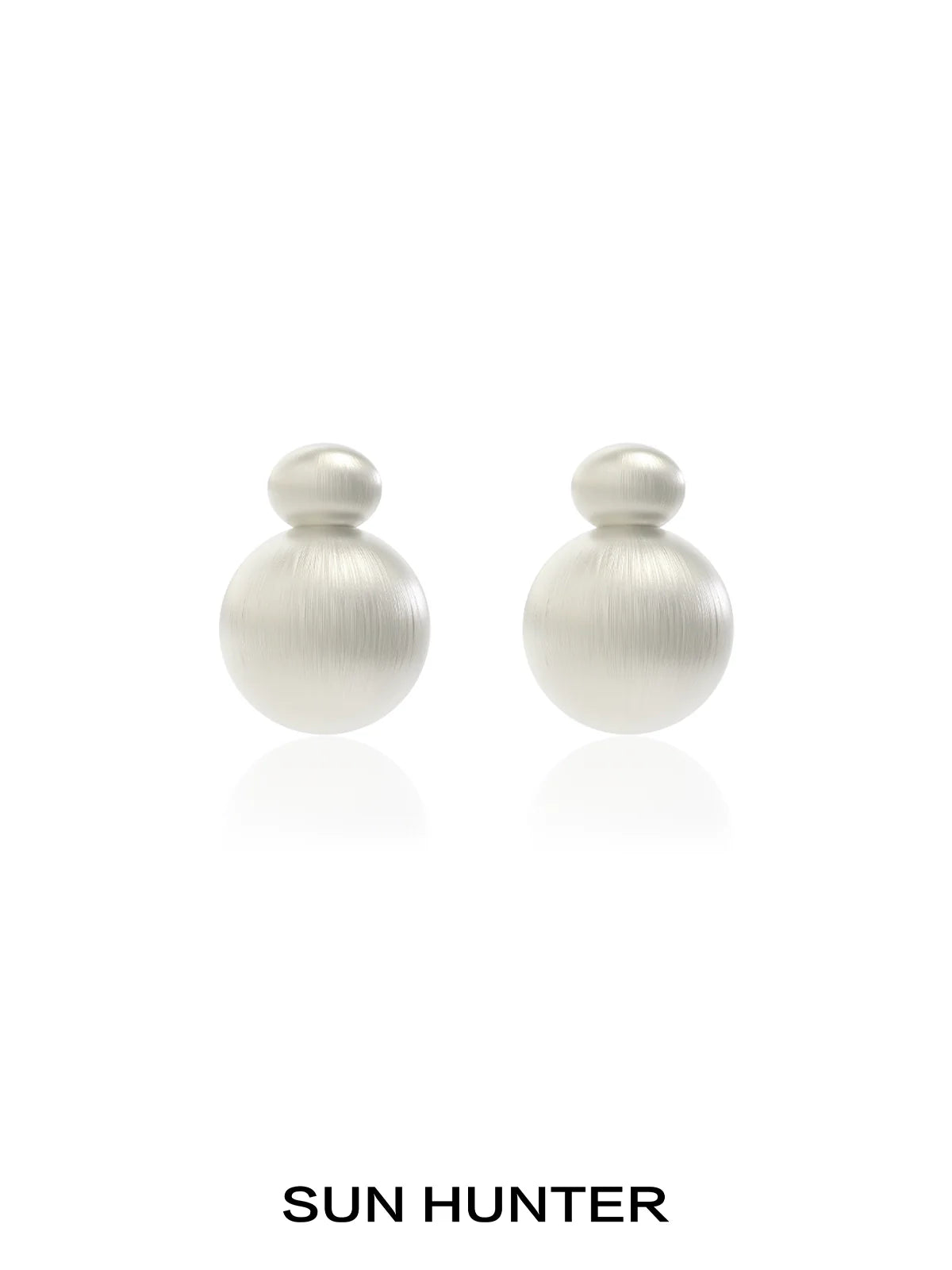 Elegant vintage cocoon earrings in soft metallic finish by SUN HUNTER, perfect for any occasion