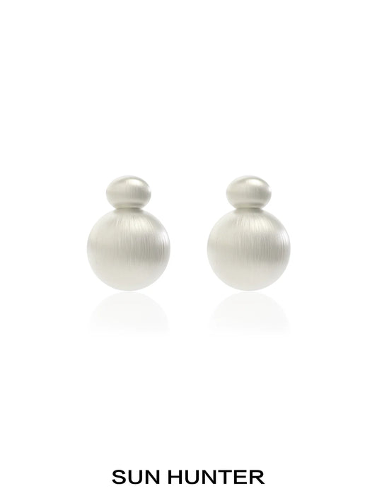 Elegant vintage cocoon earrings in soft metallic finish by SUN HUNTER, perfect for any occasion