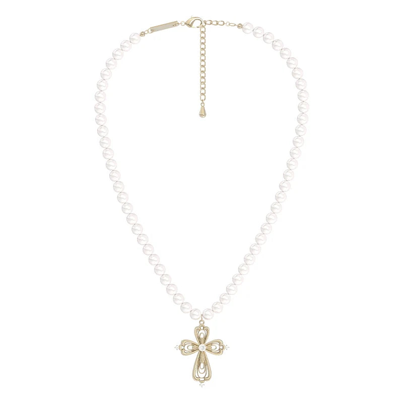 Vintage cross pearl necklace featuring a decorative cross pendant on a pearl strand