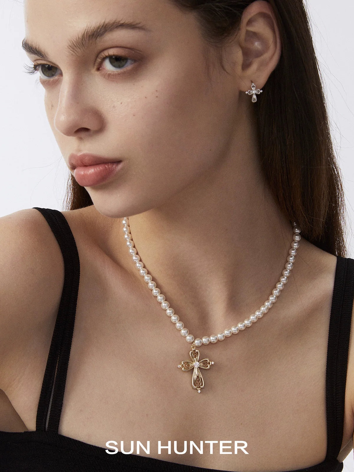 Elegant vintage cross pearl necklace with a delicate gold cross centerpiece by SUN HUNTER