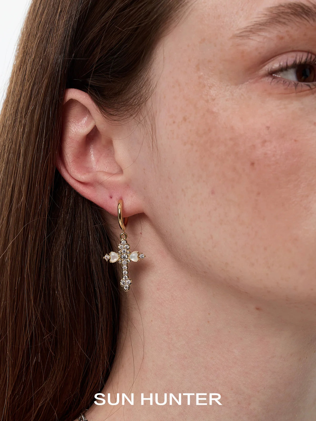 Elegant SUN HUNTER vintage cross zircon earrings featuring sparkling stones and a gold hoop design