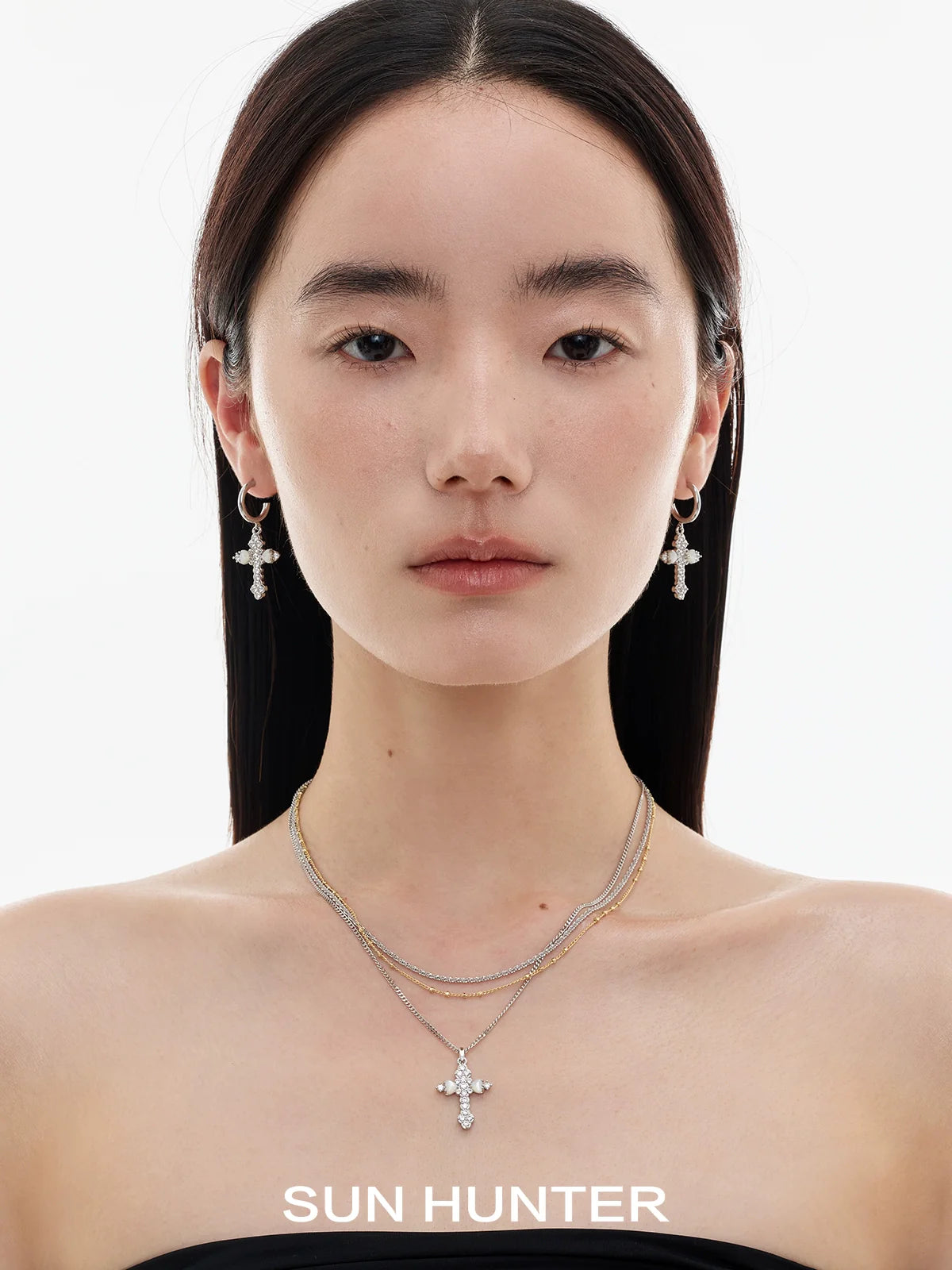 Model wearing vintage cross zircon earrings by SUN HUNTER for a stylish look
