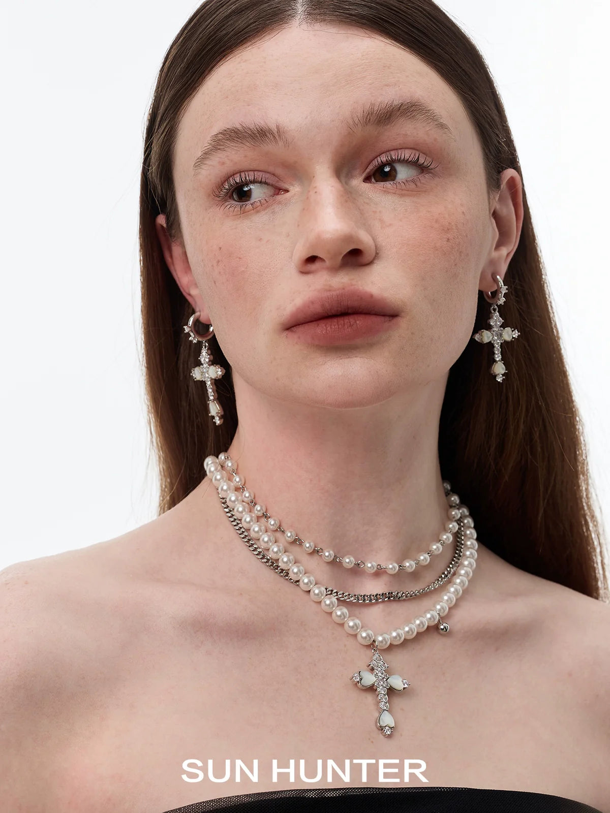 Elegant SUN HUNTER vintage cross zircon earrings with intricate design and shimmering details
