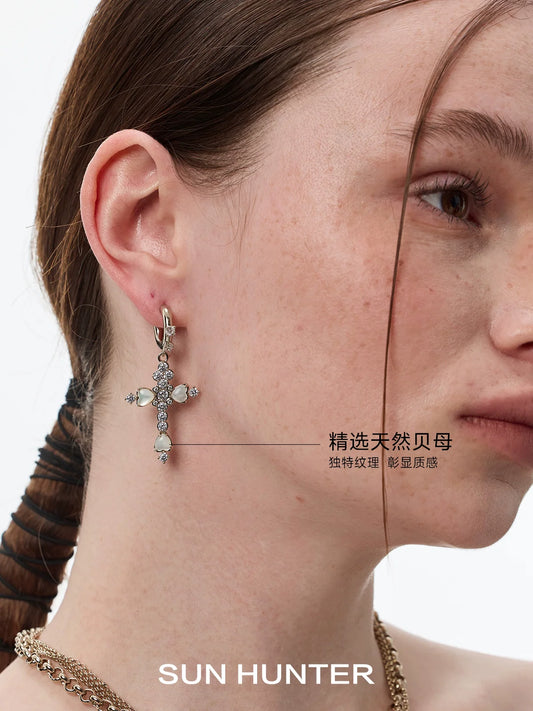 SUN HUNTER vintage cross zircon earrings displayed elegantly on a model's ear