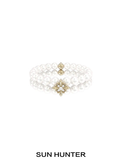 Elegant SUN HUNTER vintage iris pearl bracelet featuring lustrous pearls and a decorative centerpiece