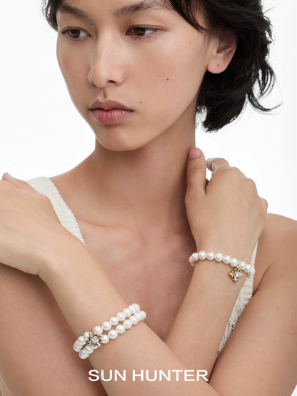 Model wearing a vintage iris pearl bracelet showcasing elegant design and charm detail