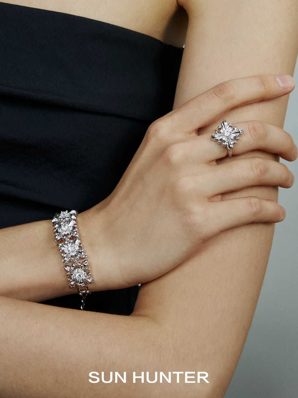 Elegant SUN HUNTER vintage iris square ring displayed on model's hand with matching bracelet