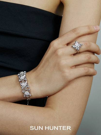 Elegant SUN HUNTER vintage iris square ring displayed on model's hand with matching bracelet
