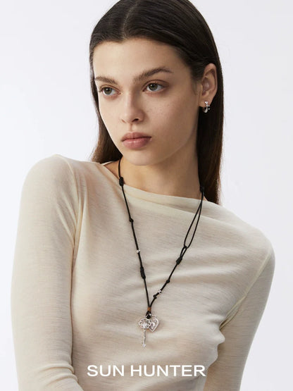 Model wearing vintage lace earrings and a heart-shaped pendant necklace by SUN HUNTER