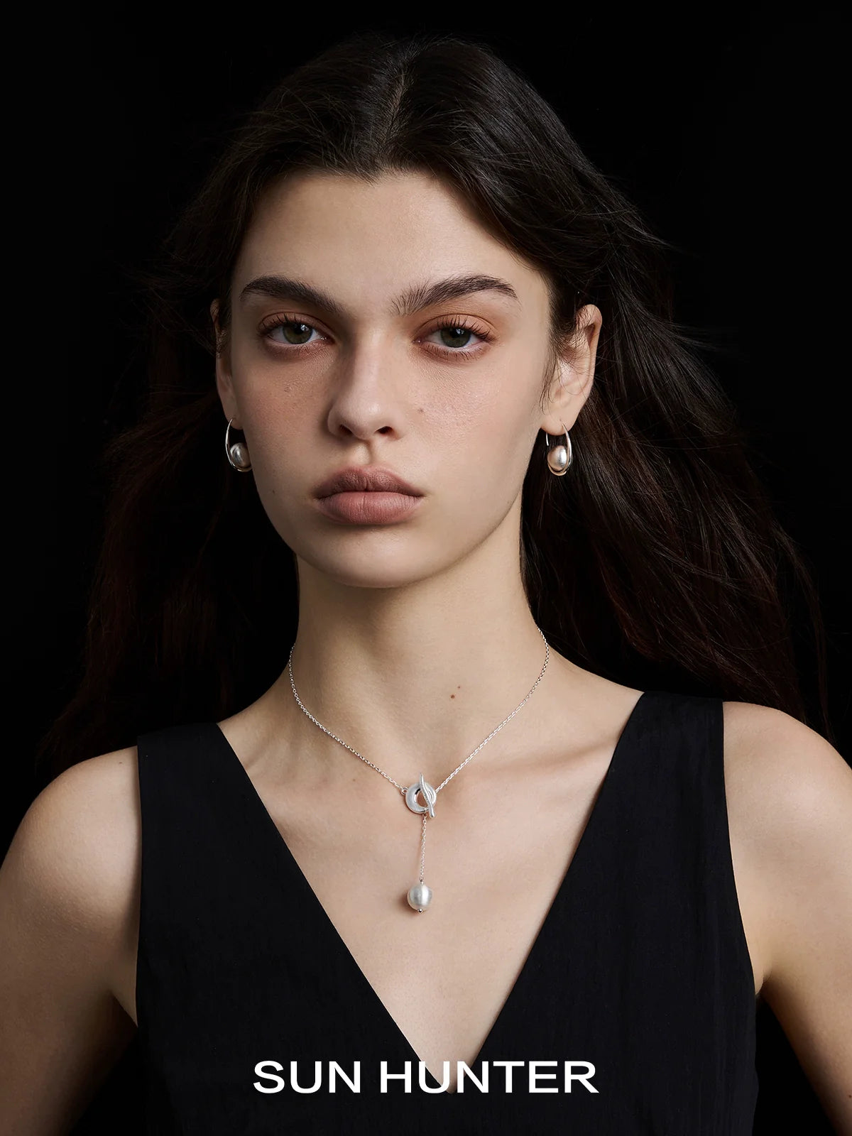 Model wearing SUN HUNTER vintage orbital earrings paired with a matching necklace in elegant styling