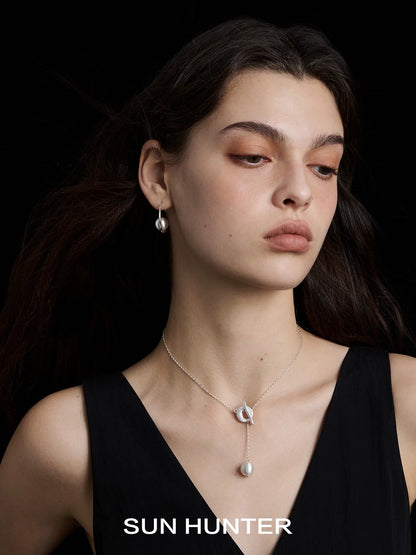 Elegant model wearing SUN HUNTER vintage orbital earrings showcasing timeless design and sophistication