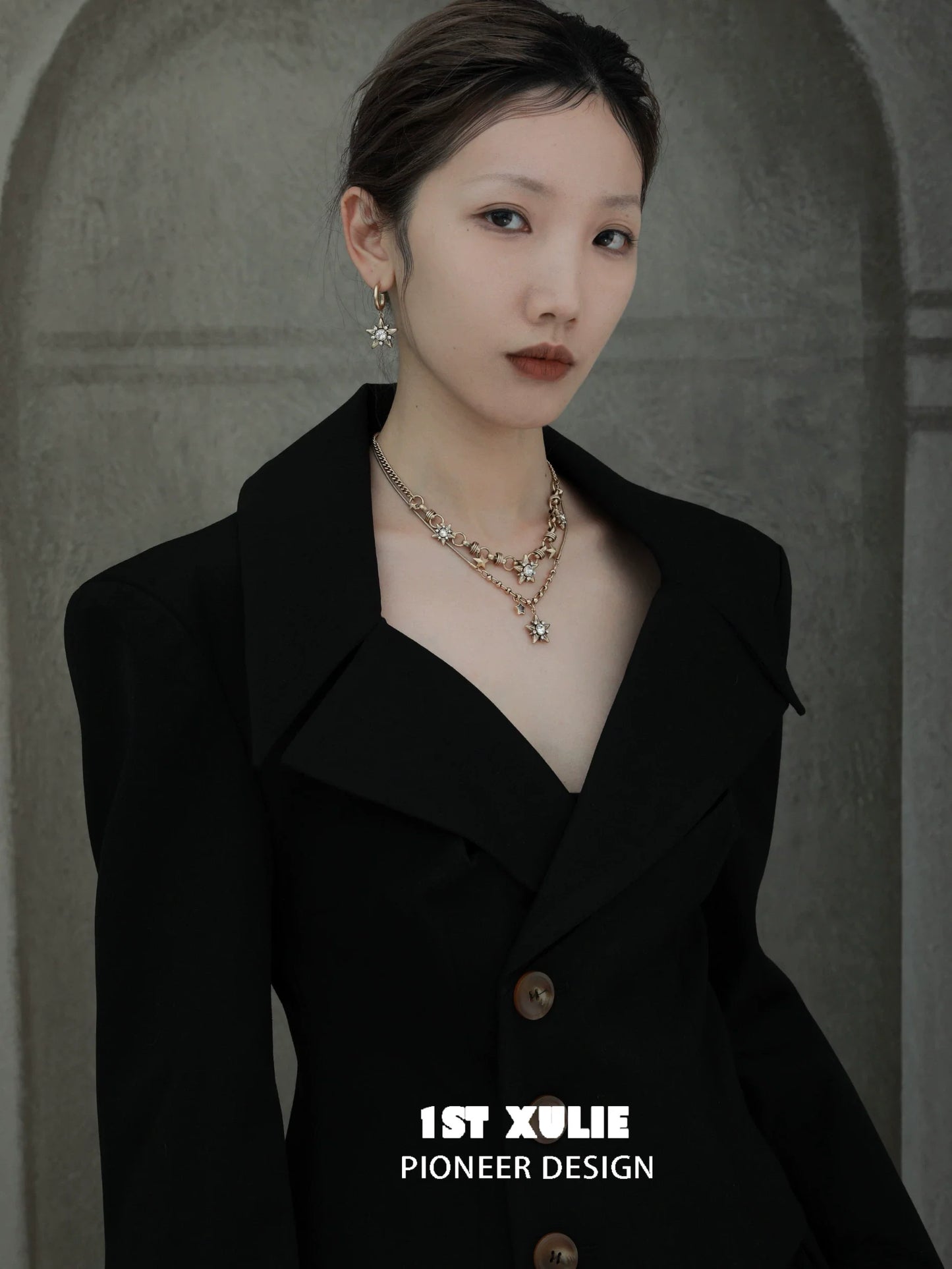 Model wearing a vintage starlight pendant necklace paired with a stylish black blazer