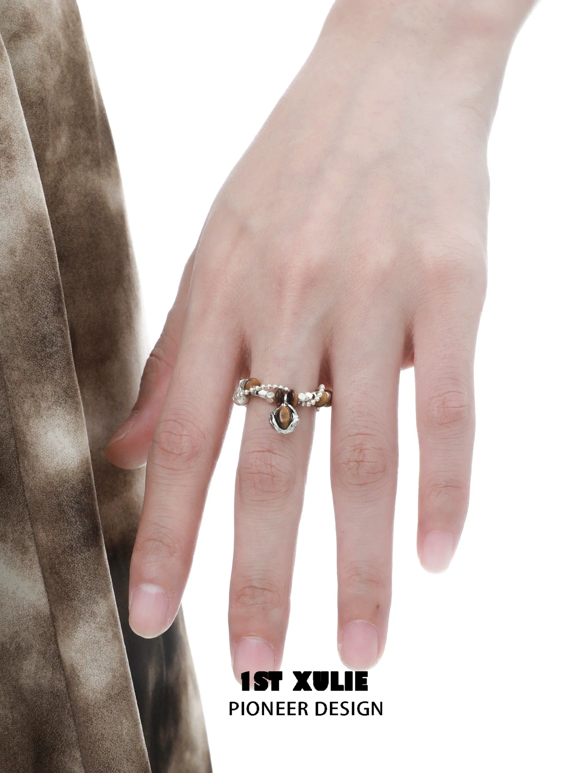 Vintage tiger's eye silver ring showcased on a hand with delicate detailing and gemstone