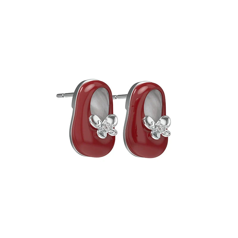 Red vintage walking shoe earrings with flower accents and silver detailing for stylish accessory lovers