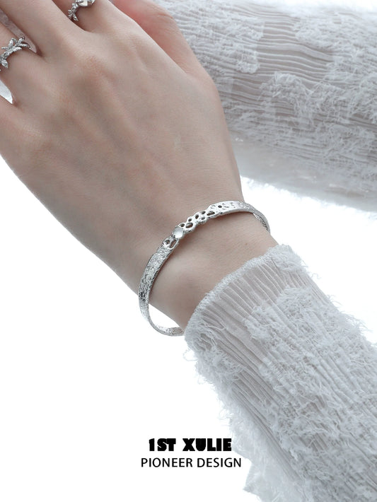 Elegant white agate bangle bracelet on a woman's wrist, featuring a textured design