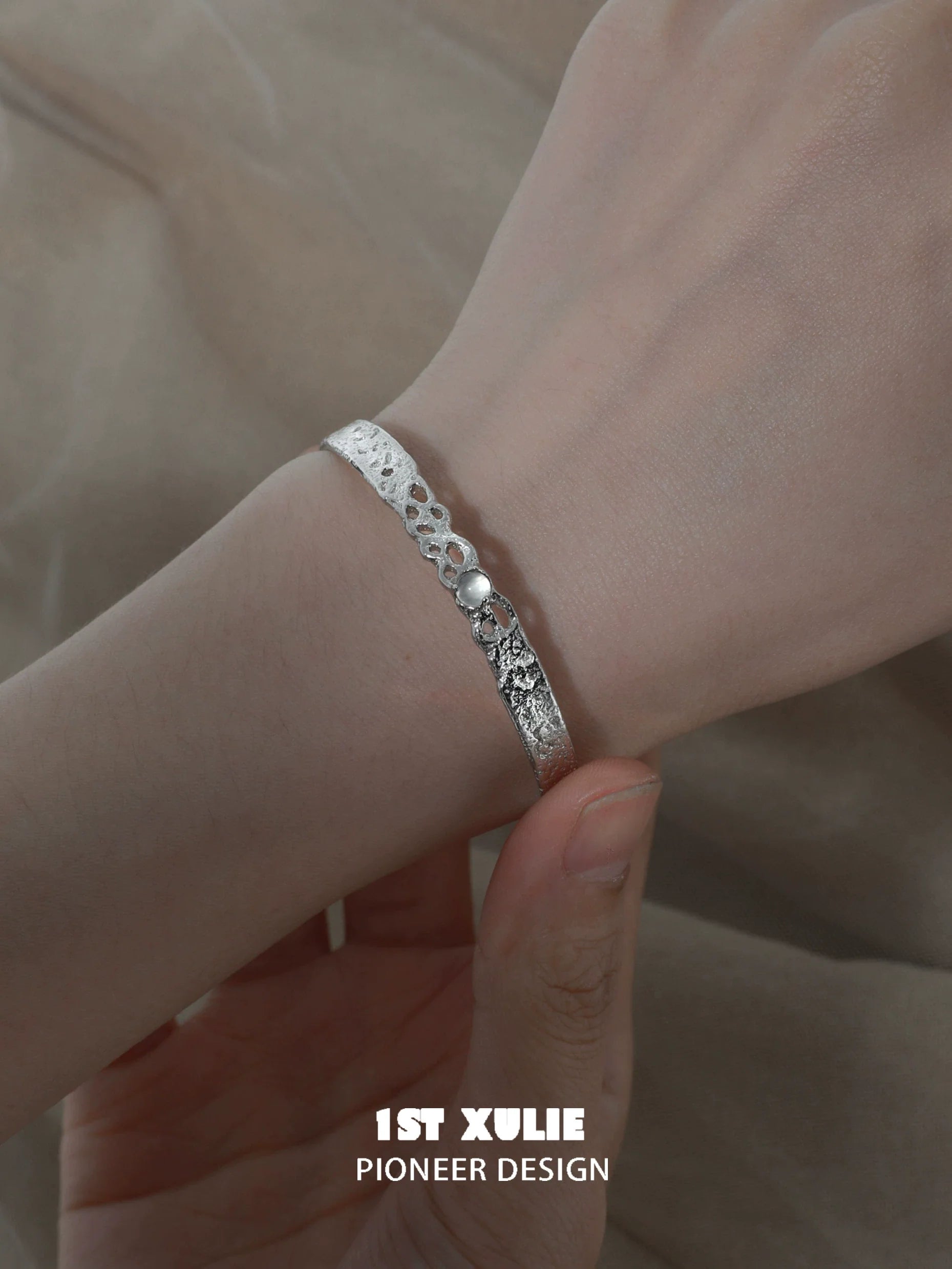 Elegant white agate bangle bracelet displayed on a hand, showcasing its intricate design