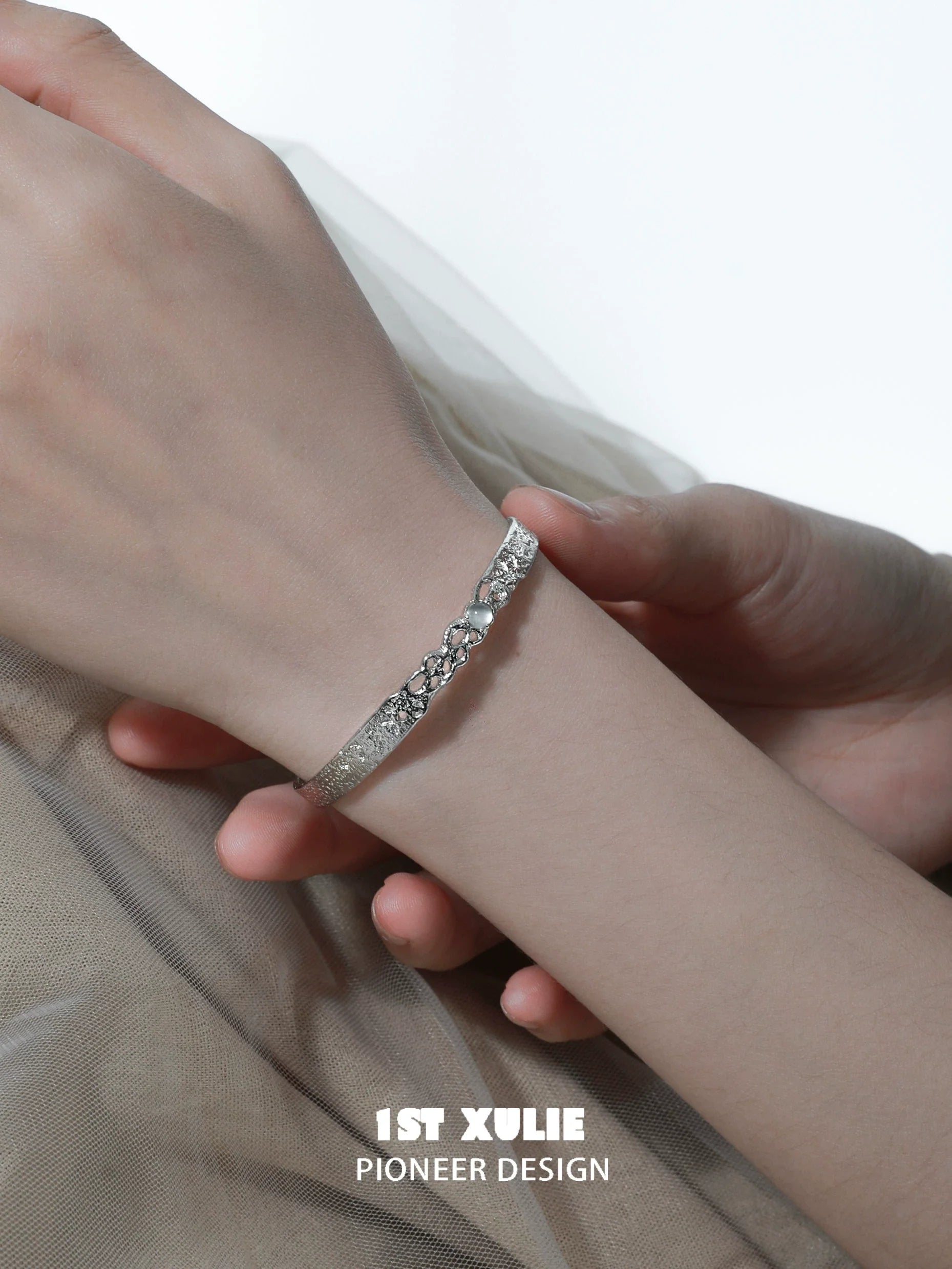 Stylish white agate bangle bracelet showcased on a model's wrist with elegant design