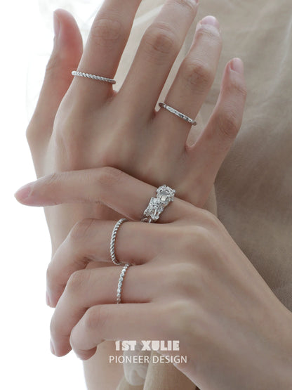 Elegant white agate ring showcased alongside other delicate silver rings on a hand