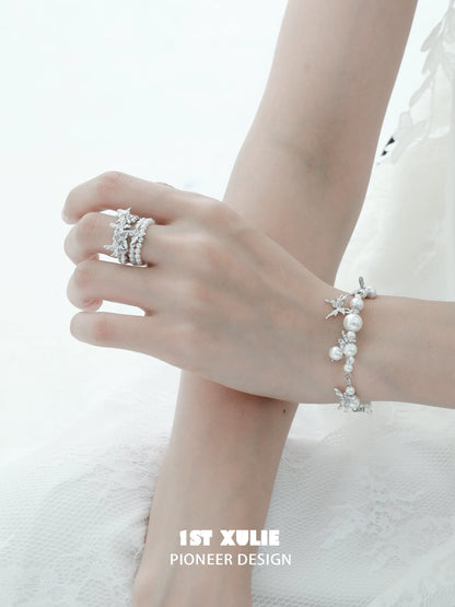 Elegant white butterfly pearl bracelet showcased on a delicate hand with matching silver jewelry