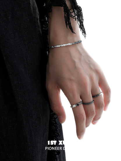 Y2K black and white couple bracelet displayed on a hand with intricate detailing