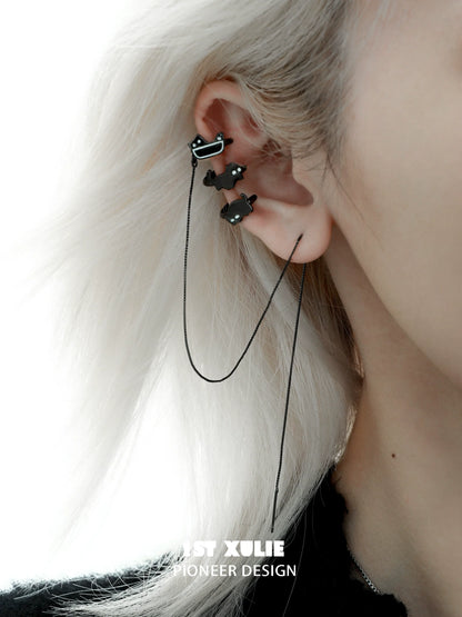 Y2K black cat ear cuffs with a sleek design, stylishly worn on a model's ear
