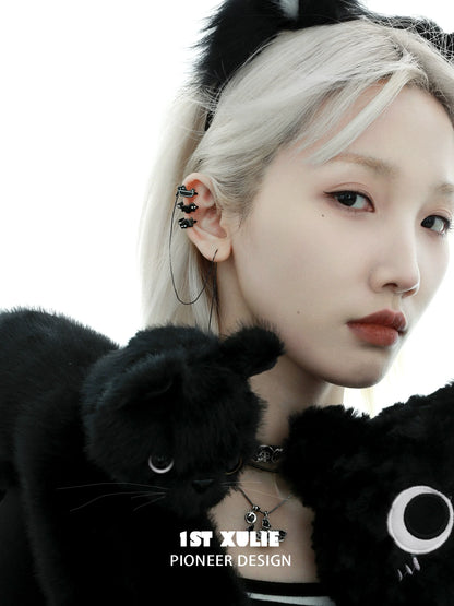 Y2K black cat ear cuffs worn by a model with plush black cat accessories