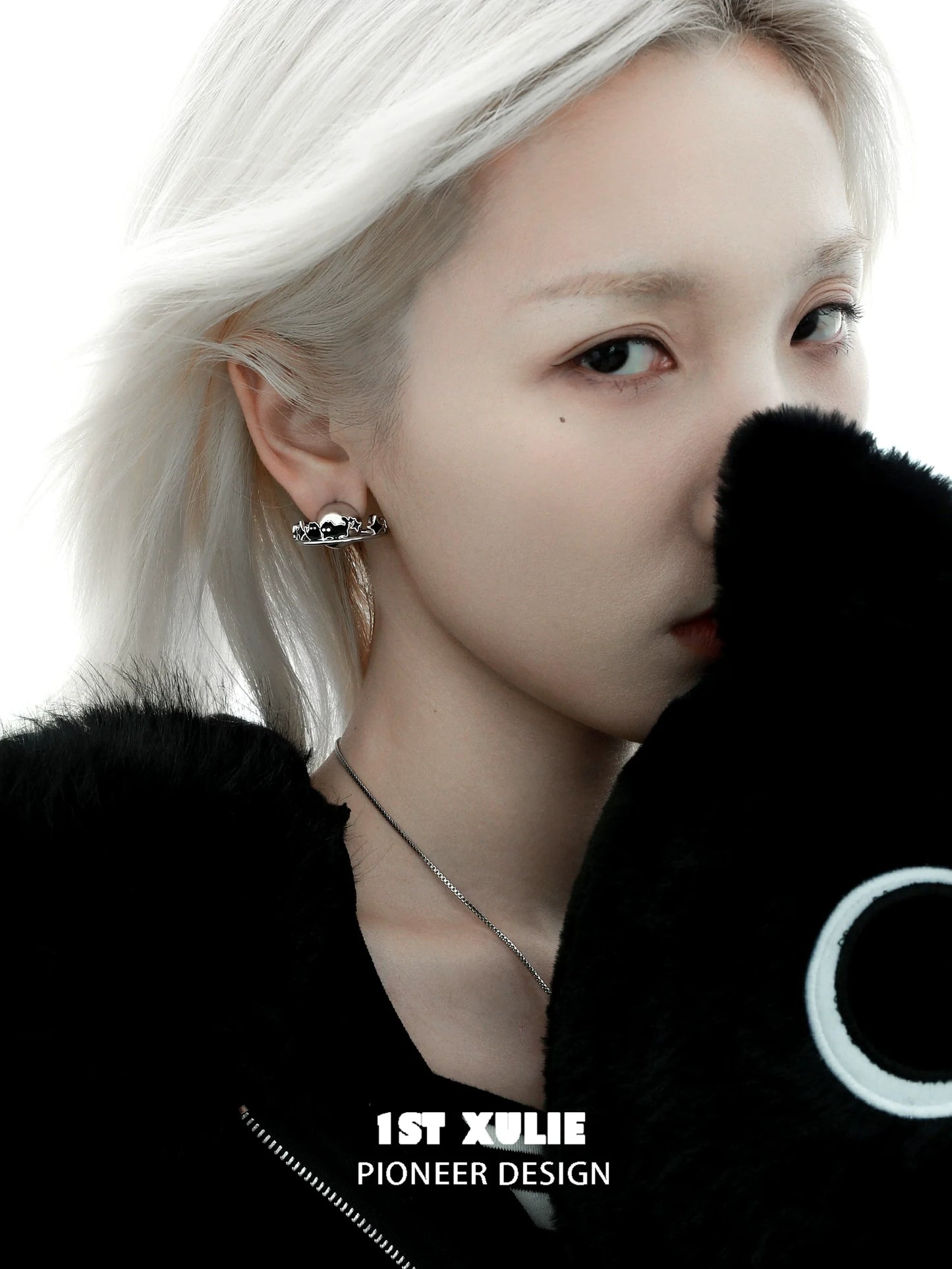 Y2K black cat earrings displayed on model with silver hair and black plush toy