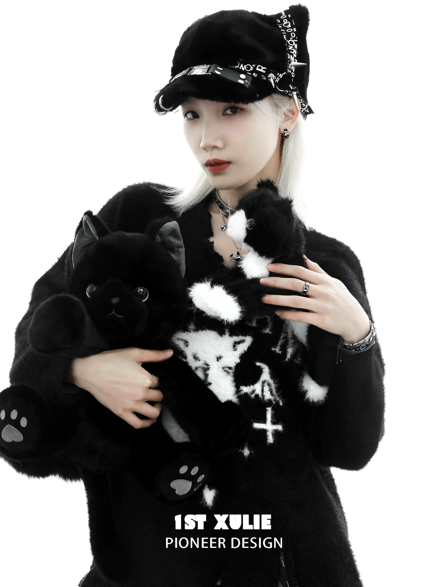 Y2K black cat ring worn by model holding cute black cat plush toys in stylish fashion outfit