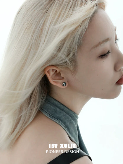 Y2K black silver stud earrings showcased on a model with sleek blonde hair