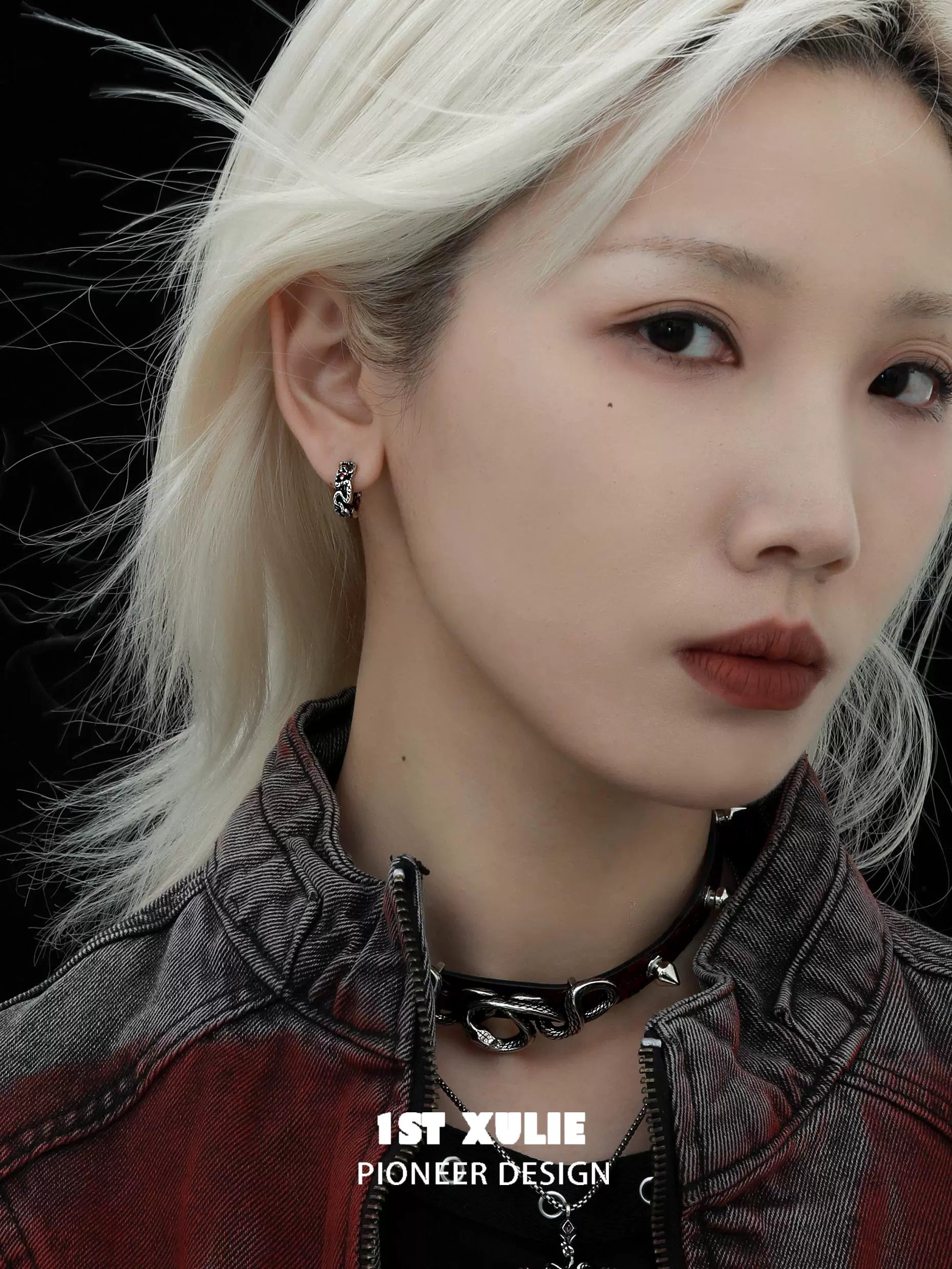 Y2K black snake earrings dangling from a model's ear, adding a trendy touch to her edgy style