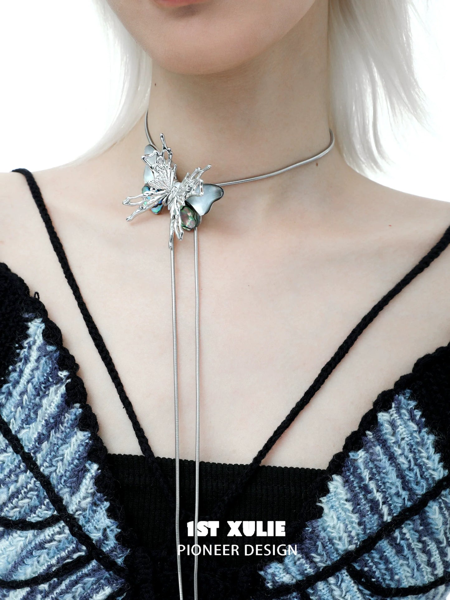 Y2K butterfly necklace with silver accents and a unique design worn on a model