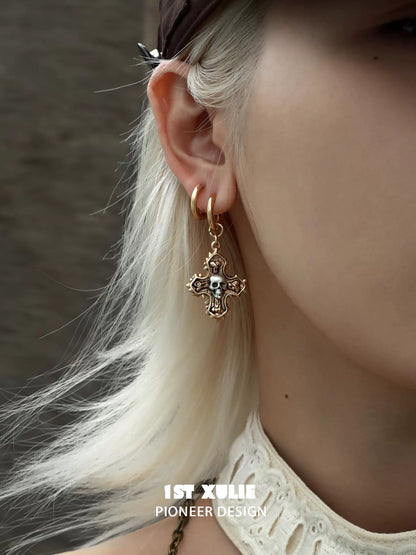 Y2K cross earrings with skull detail, adding a unique and edgy touch to any outfit