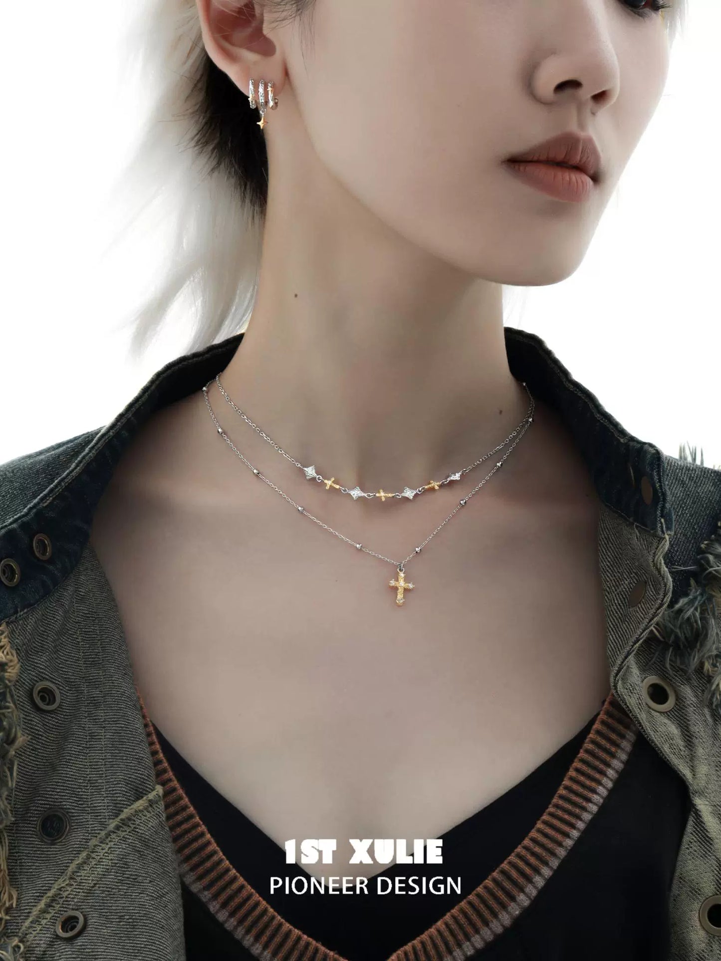 Stylish model wearing a Y2K cross necklace layered with star-themed jewelry for a trendy look