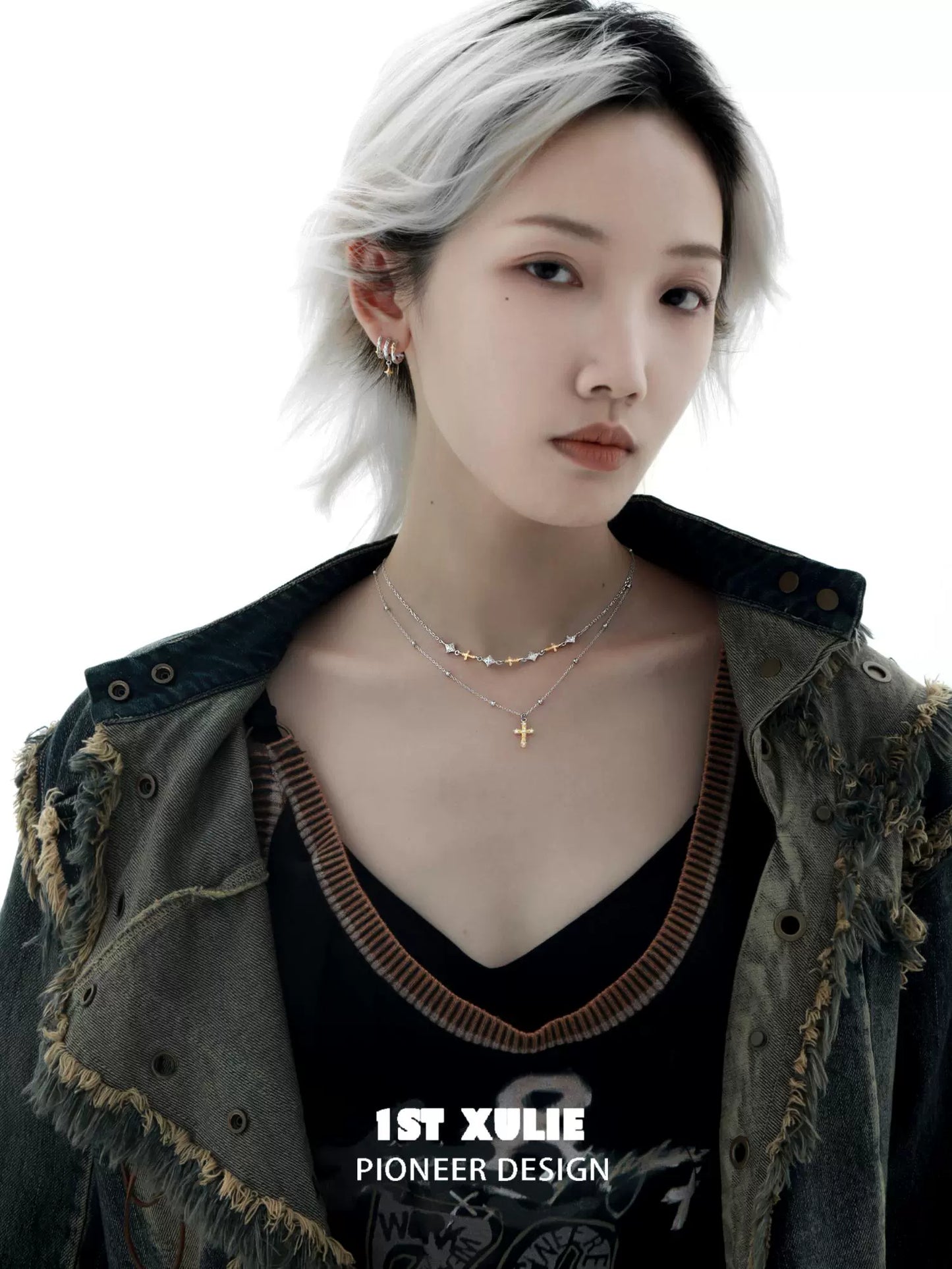 Y2K cross necklace designed by 1STXULIE featuring a layered look with delicate charms