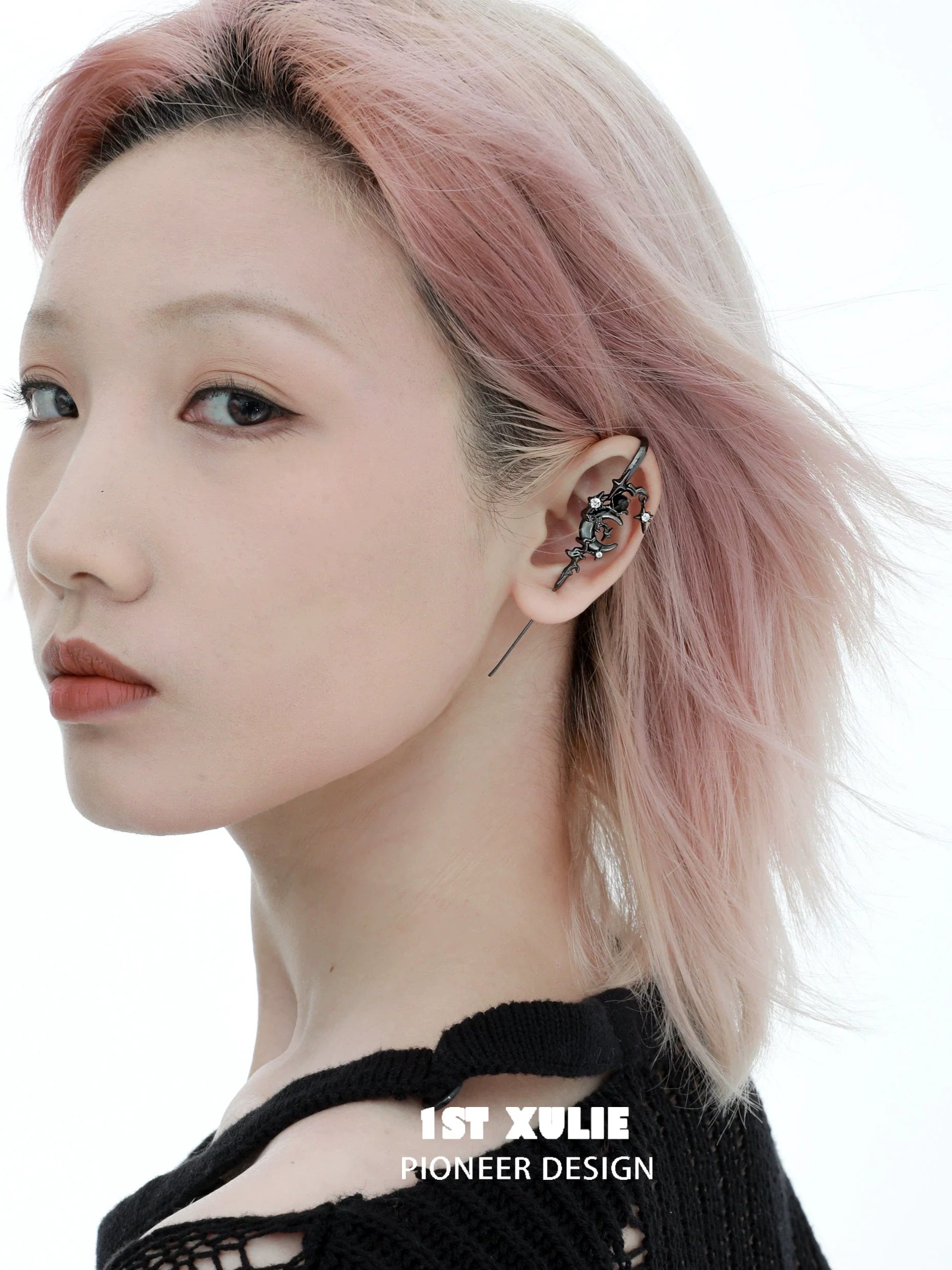 Y2K dark moon ear piercing design displayed on model with stylish pink hair