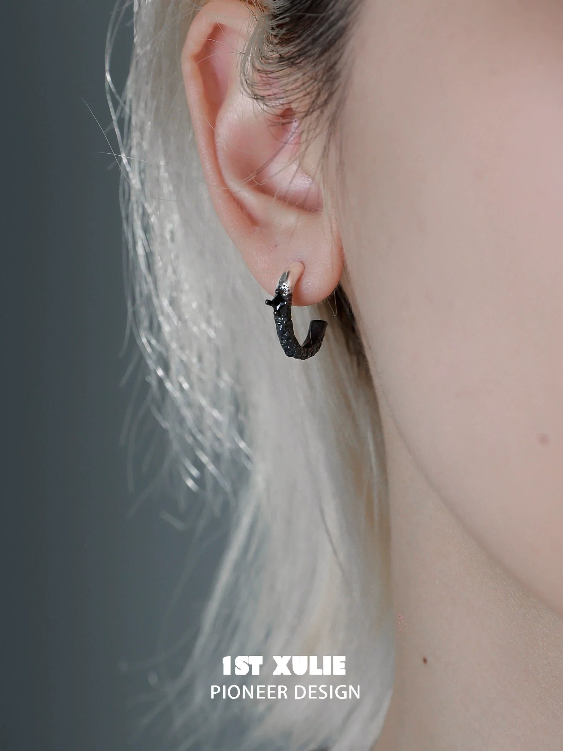 Y2K fire earrings in black, showcasing a unique design worn on a model's ear