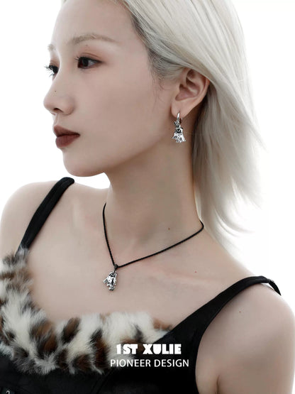 Y2K ghost black cat earrings in silver, worn by a model with a sleek hairstyle