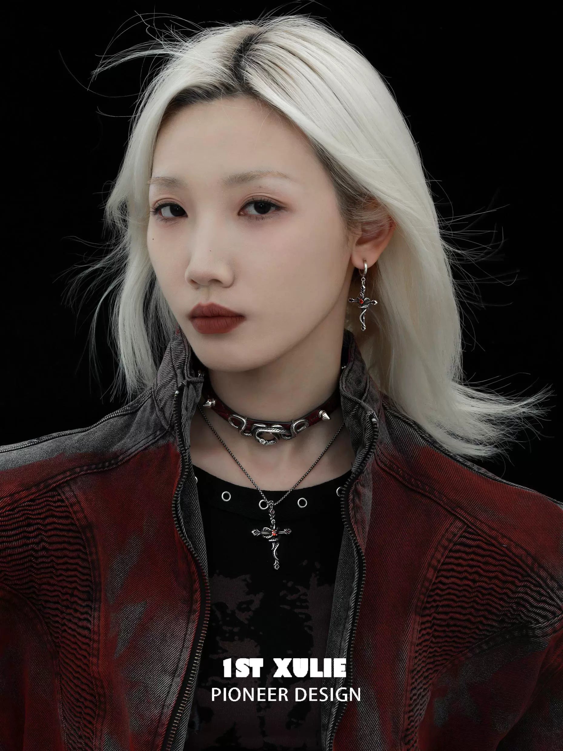 Model wearing Y2K gothic cross earrings alongside a stylish jacket and layered necklaces