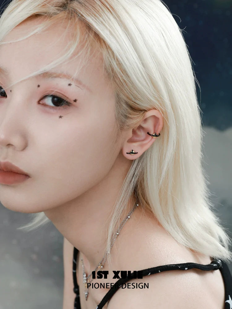 Model showcasing Y2K lonely dreamer earrings with a stylish minimalist design and a cosmic background