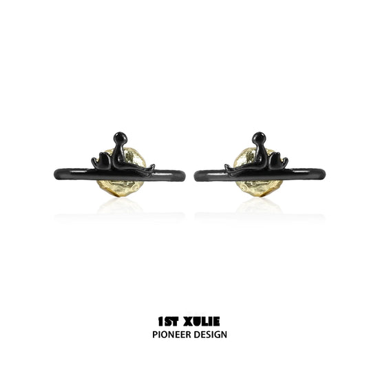 Y2K lonely dreamer earrings featuring a unique design with a gold and black finish